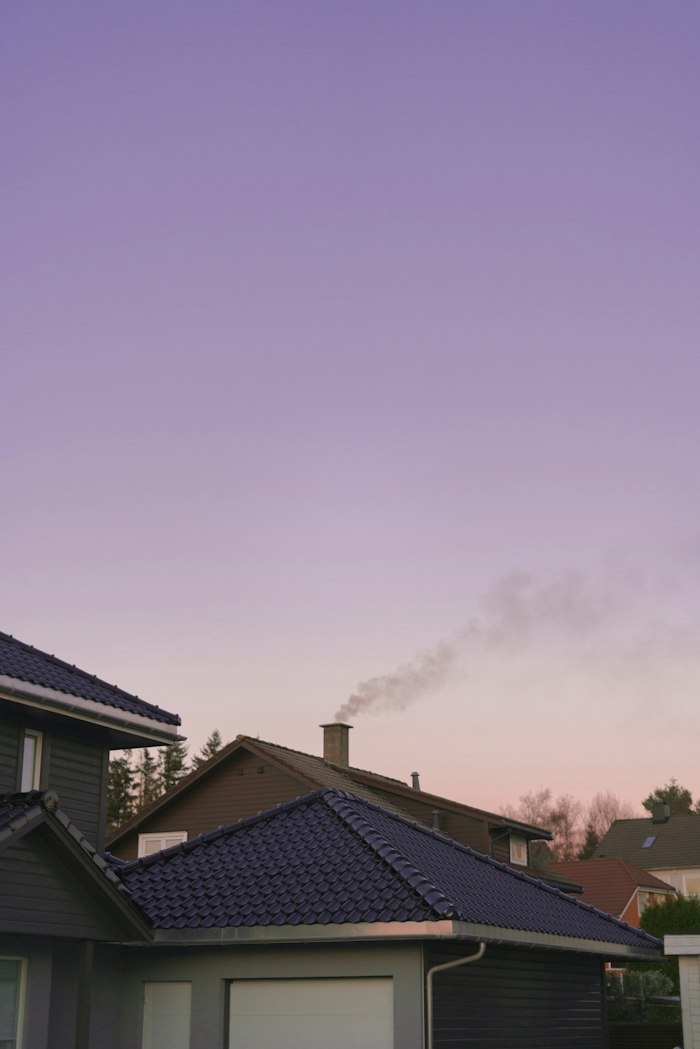Chimney smoke against a dusk sky